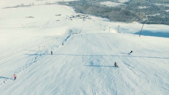 Several People Rides Ski Downhill.