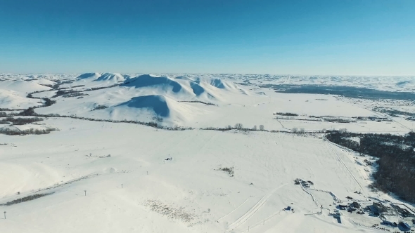 Aerial Shot of Mountains and Fields By Ski Resort