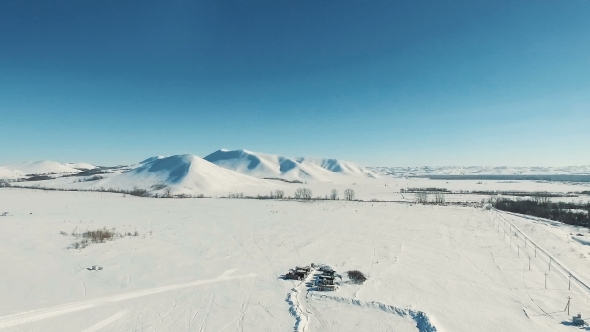 Aerial Shot of Mountains and Fields By Ski Resort.