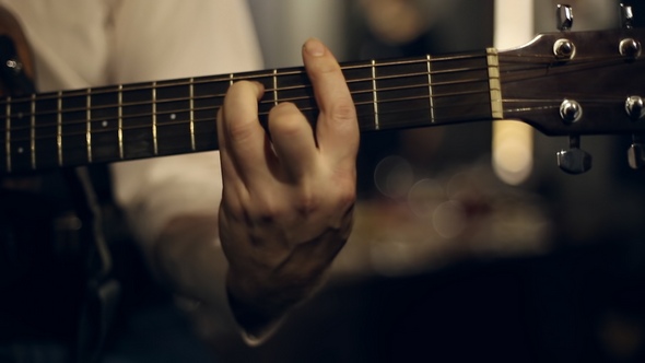 Guitarist Plays on the Guitar alt