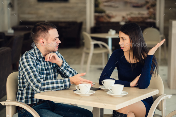 Young couple arguing in a cafe. Relationship problems. - Stock Photo - Images