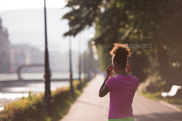 portrait of young african american jogging woman Stock Photo by dotshock