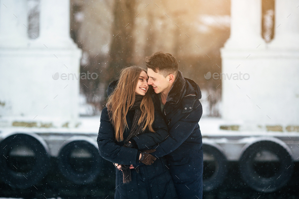 guy hugging his girlfriend from behind - Stock Photo - Images