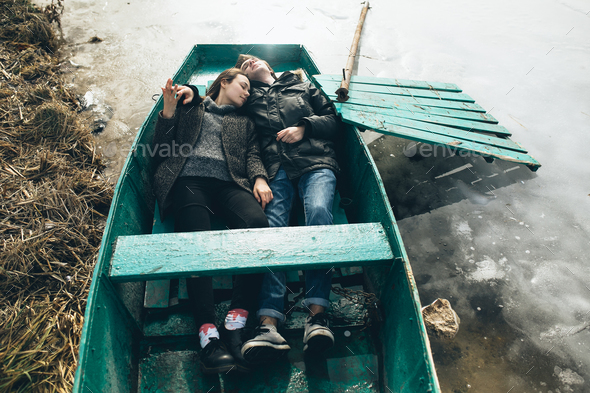 man and woman lie in the boat - Stock Photo - Images