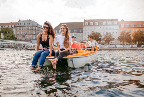 Young people on pedal boat in lake
