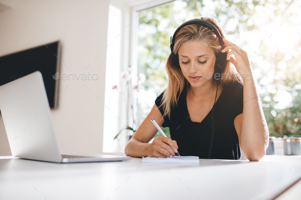Woman studying in kitchen - Stock Photo - Images