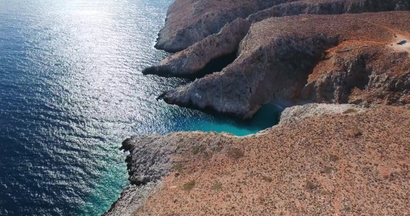 Blue Sea, Waves Breaking in Cliffs at Shore