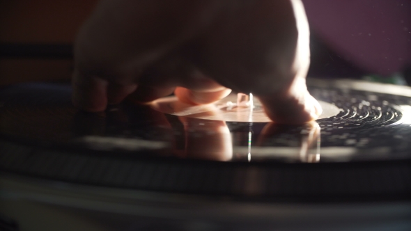 Man's Hand Scratching Vinyl Record alt