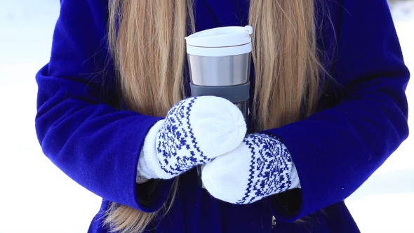 Female Hands with Thermal Coffee Mug in Winter Day alt