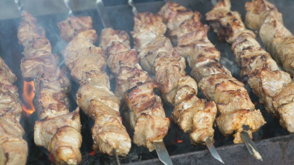 Frying of Marinated Meat on Metal Skewers on Coals