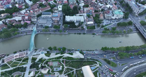 Aerial view of Tbilisi city central park and Bridge of Peace. Beautiful cityscape of old Tbilisi at alt