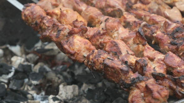 Cooking of Pork Shashlik on Skewers on the Grill
