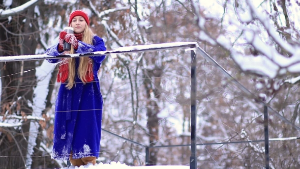 Cheerful Woman Drinking Mulled Wine in Winter alt