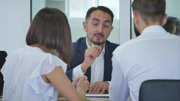 Car Dealer Signing a Contract To Purchase and Giving the Key To a New Car To a Young Attractive