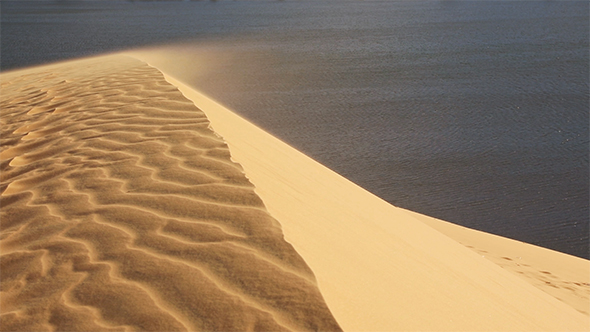 Sand Blowing Over The Dunes