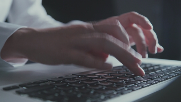 Woman Hands in White Blouse Typing on Keyboard in the Evening Light.
