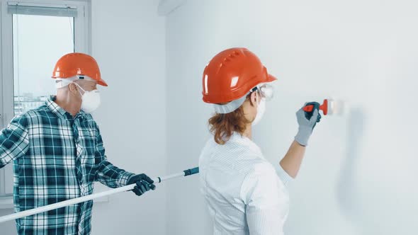 An Elderly Married Couple a Man with a Beard and a Woman in Protective Masks and Helmets are