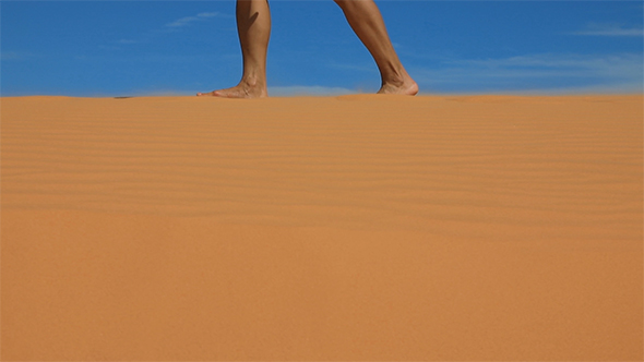 Women's Feet Walking on a Sandy Dunes