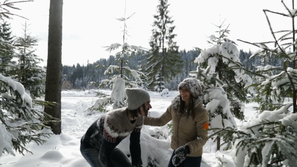 Couple Winter Forest Walking Man And Woman Throwing Snow Having Fun In Snowy Park
