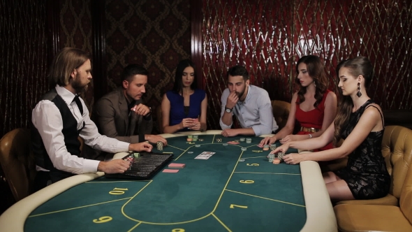The Company of Players at the Poker Table Place Their Bets