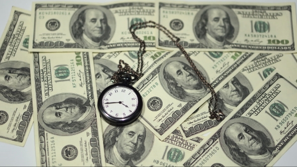 Time Is Money - a Pocket Watch on a Background of One-hundred Dollar Bills