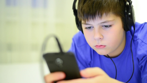 Teen Using Cell Phone with Headphones