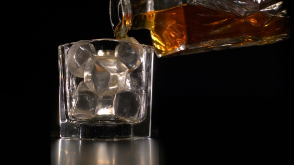 Whiskey on the Rocks Poured From a Rystal Decanter