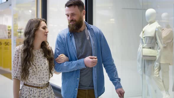 Video of couple strolling in shopping mall. Shot with RED helium camera in 8K. alt