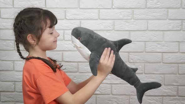 Child with soft friend toy.  alt