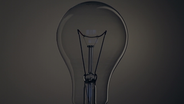 Light Bulb on Black Background. alt