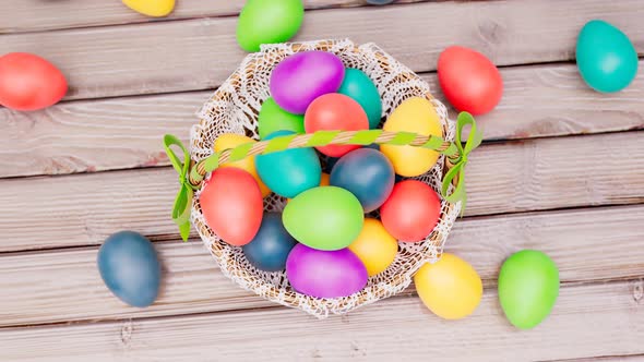 Traditional Easter basket full of cloured eggs while spring celebration. alt