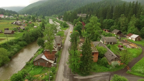 Aerial Footage Along the River Road in the Mountain Village and Forest