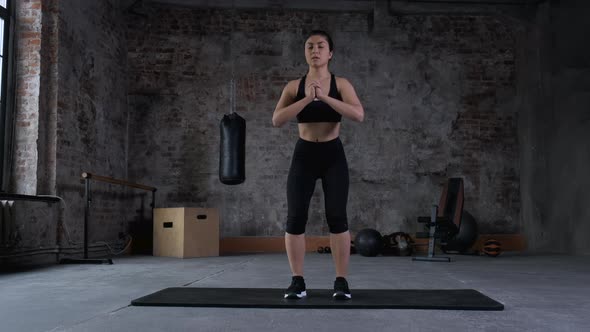 Strong and Fit Beautiful Athletic Woman in Sport Top and Shorts is Doing Squat Exercises alt