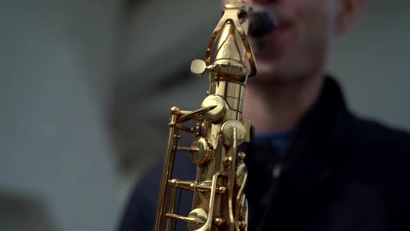 Saxophone in Hands of Young Skilled Musician, Man Is Playing Song on Instrument alt