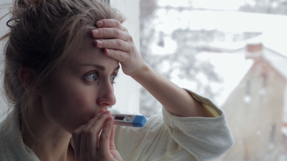 Sick Woman with Thermometer