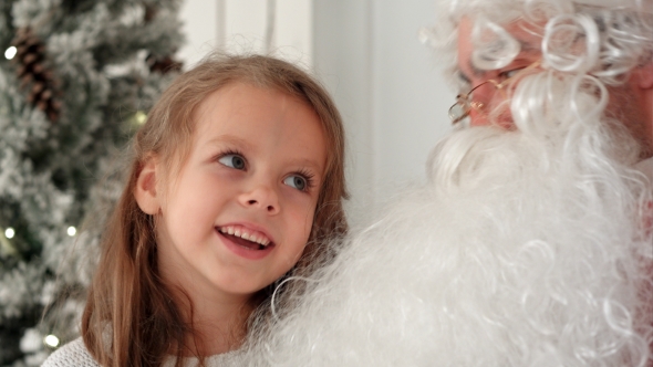 Cute Little Girl Singing Christmas Song Together with Santa Claus alt