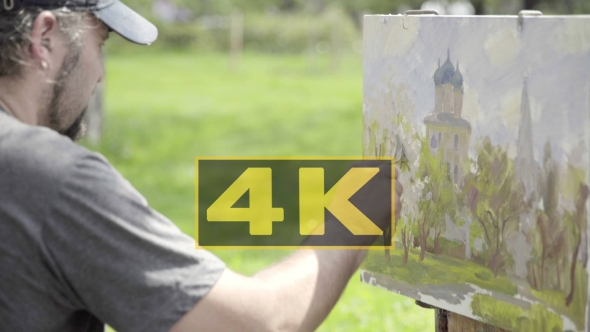 Concept Snow-white Spring. Skilled Artist Draws Paints of Blossoming Apple Tree alt