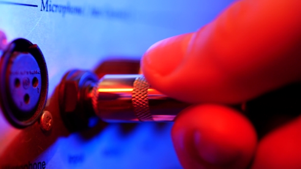 Man Connects the Jack To the Amp alt