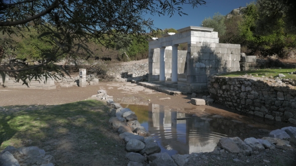 Facade of the Ancient Temple with Columns Reflection in the Water, Kaunos, Dalyan Valley, Turkey.