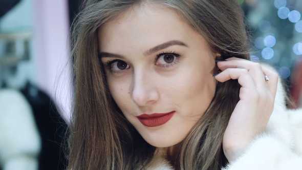 Beautiful Girl Chooses a Fur Coat in the Shop, Stock Footage | VideoHive