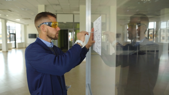 Architect Builder Studying Layout Plan of the Rooms, Serious Civil Engineer Working with Documents alt