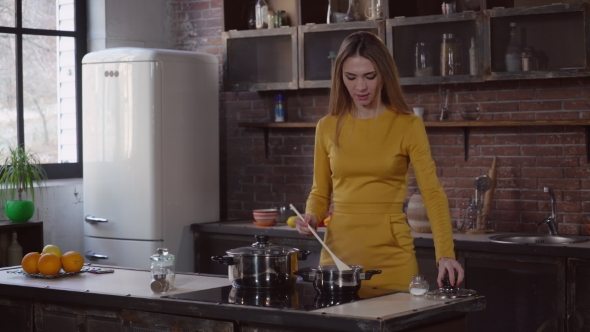 Woman Cooking Sauce in a Flat alt