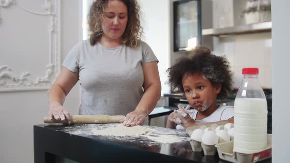 Family Baking  Black Little Girl and Her Mother Rolling Out the Dough with a Skipping Rope alt