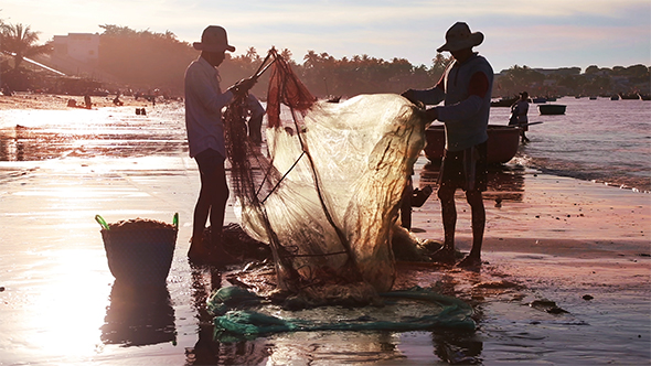 Vietnamese Fishermen in The Setting Sun