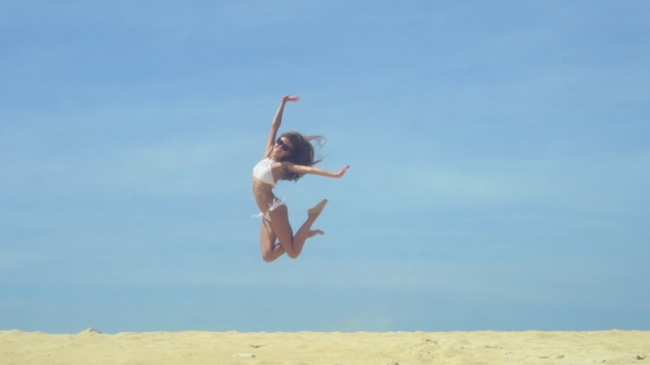 Happy Free Girl Jumping On The Beach