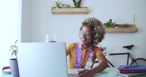 Woman Making a Video Call at Home and Toasting with a Glass of Wine alt