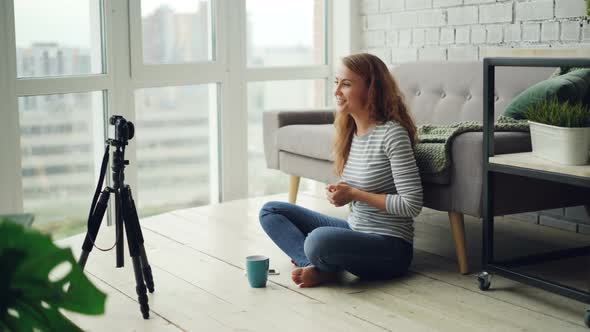 Beautiful Young Woman Vlogger Is Talking and Gesturing Recording Video with Professional Camera for alt