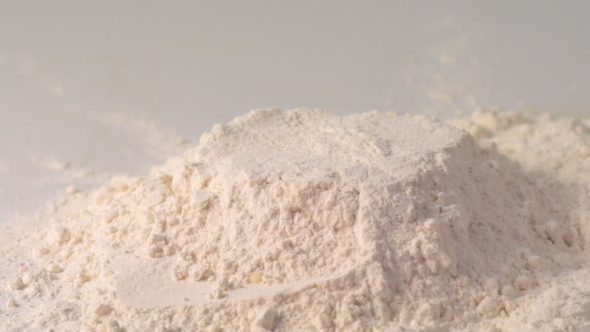 Egg Falling Down Into Flour