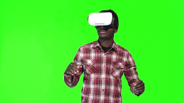 African Man Wearing VR Googles on Green Screen alt