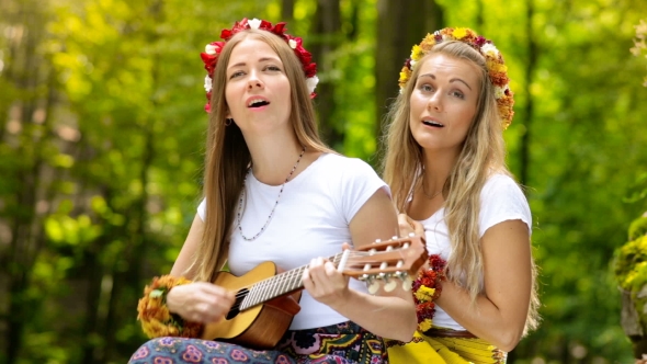 Two Young Girls with Guitar in a Summer Forest alt